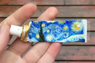 A tiny painting of Van Gogh's Starry Night on a paint tube