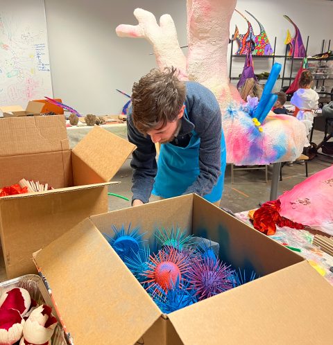 volunteer working on sea life sculpture for blacklight art installation