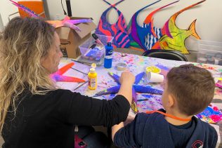 volunteer working on sea life sculpture for blacklight art installation